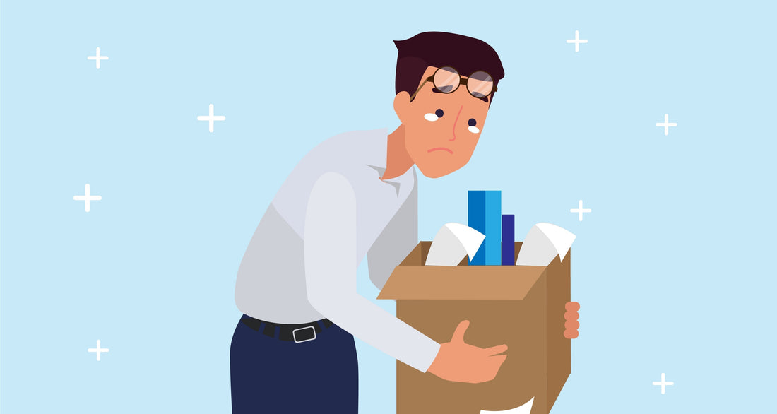 weary man carrying a box of paperwork